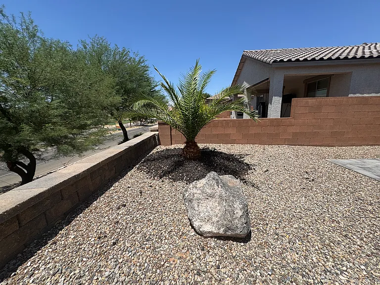 Backyard corner featuring desert landscaping and views of the golf course