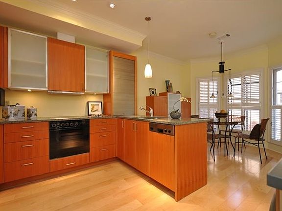 Clean, modern kitchen with efficient appliances and both a center island and an L for extra preparation space and places for guests to "hang out" during parties and gatherings!