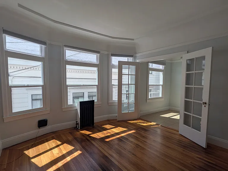 living area, separated from kitchen/dining area by original French doors