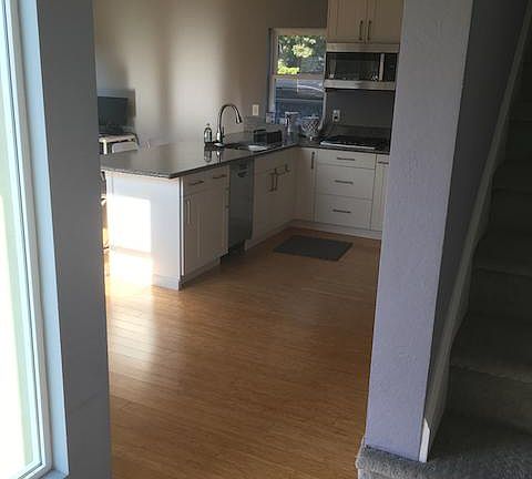 View from entryway. Upstairs to bedroom suite on the right; straight ahead into downstairs open plan kitching/dining/living area.