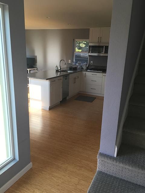 View from entryway. Upstairs to bedroom suite on the right; straight ahead into downstairs open plan kitching/dining/living area.