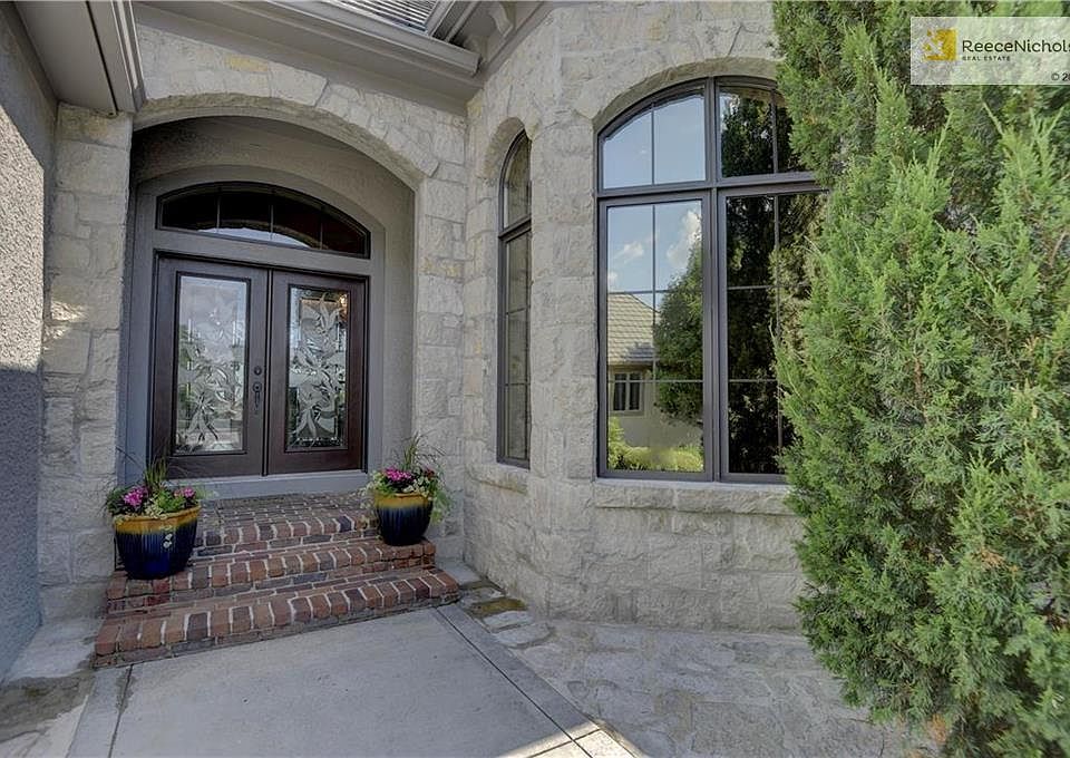 Welcome home to Your Club Villa...Brick front steps & stoop, Custom French Doors, Masonry Stucco and Stone on exterior with a Concrete Tile Roof.
