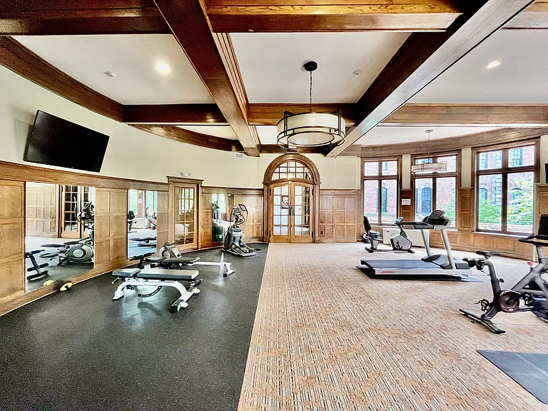 Fitness Center with treadmills and weights in the rotunda of the building with original beamed ceilings