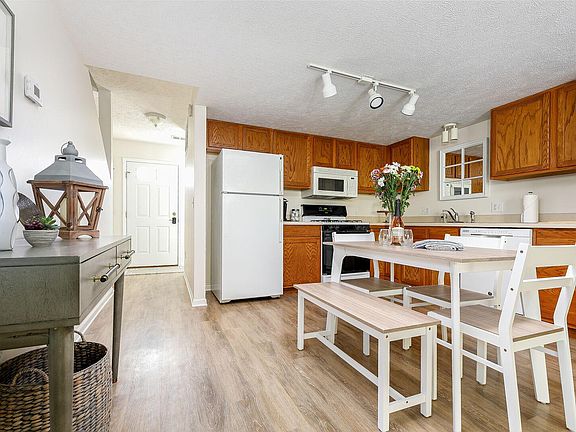 Kitchen featuring Refrigerator with Icemaker, Microwave Oven, Gas Range and Oven, Dishwasher and Disposal