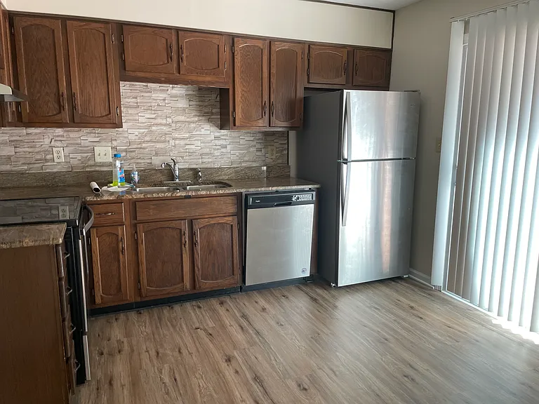 Spacious kitchen with new tile backsplash, granite and new appliances.