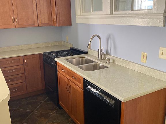 Recently renovated kitchen area with new gas stove, dishwasher and cabinets