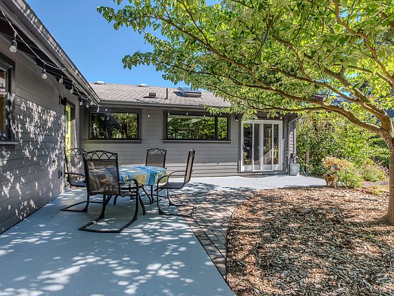 Private garden oasis with seating, owner maintains landscaping so you can enjoy.