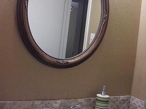 Hall bath was remodeled om 2013. Updates include this pretty mirror and nice back splash.