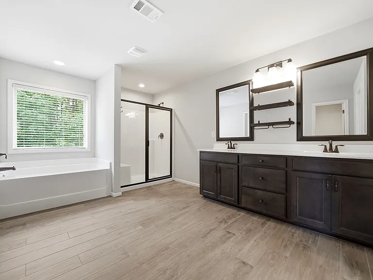 Master bath-upgraded tile floors, double vanities, accent shelving, large shower, garden tub & spacious walk-in closet