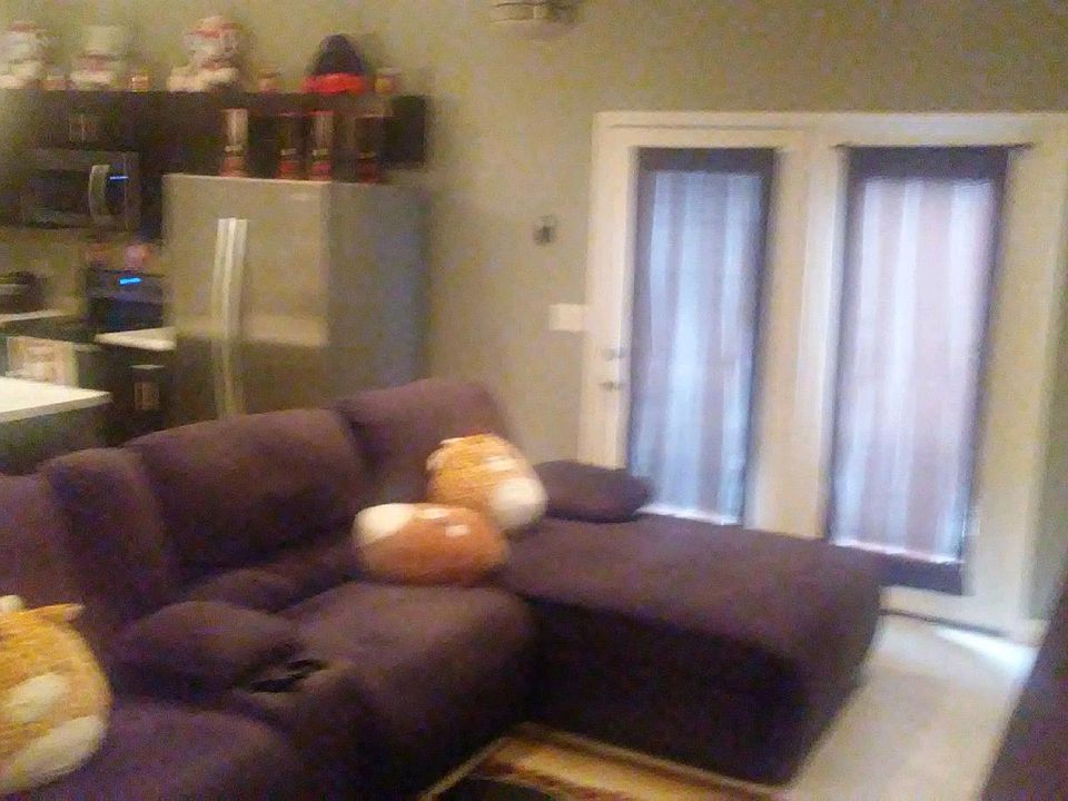 Living Room just off the Kitchen with French doors to the outside deck area.