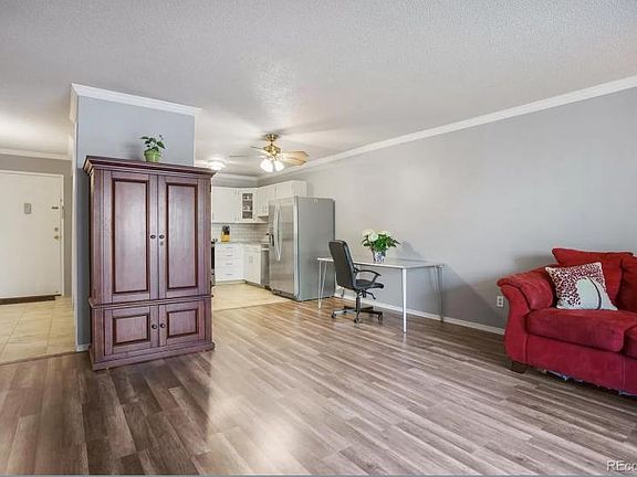 Living room facing the entry and kitchen