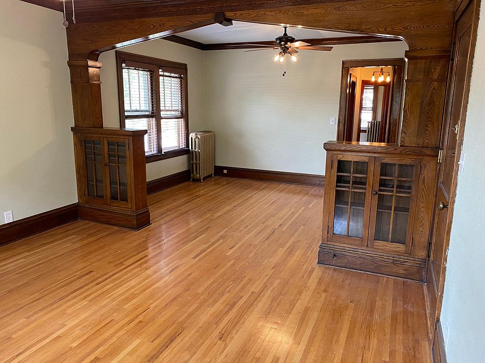 living room looking into dining room with 2 built in book cases