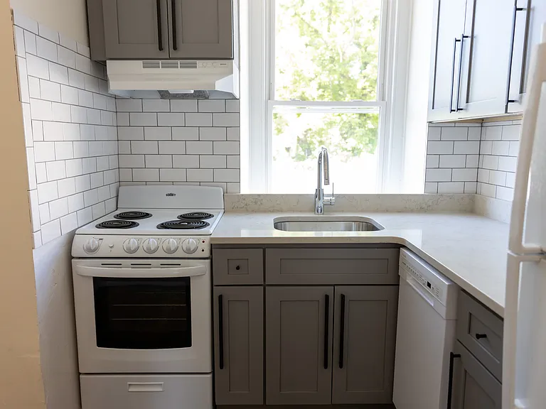 Kitchen with new stone countertops, tile backsplash, garbage disposal and updated appliances