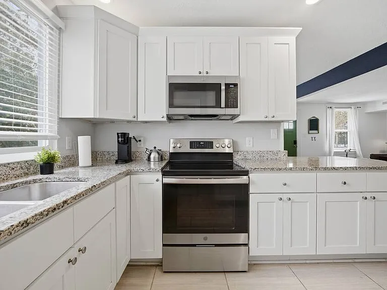 Full kitchen setup with updated appliances.