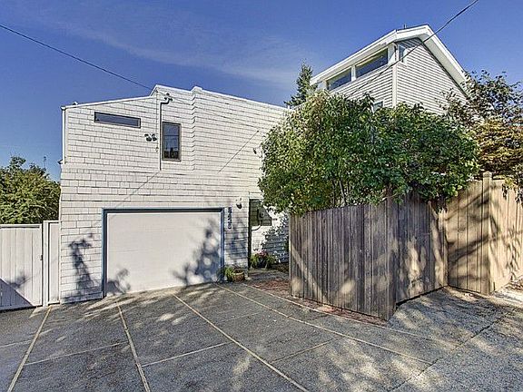 Level entry via paved alley to main floor. One car garage plus off street parking. Sweet yard with water feature too.