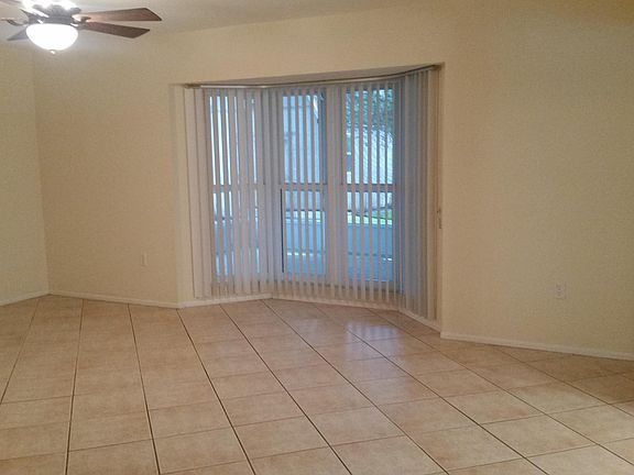 Spacious living room with bay window to lanai
