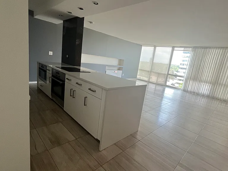 Large living room with travertine floors, beautiful wall of built-in closets, sleek appearance, floor to ceiling windows- fantastic light and Mountain Views