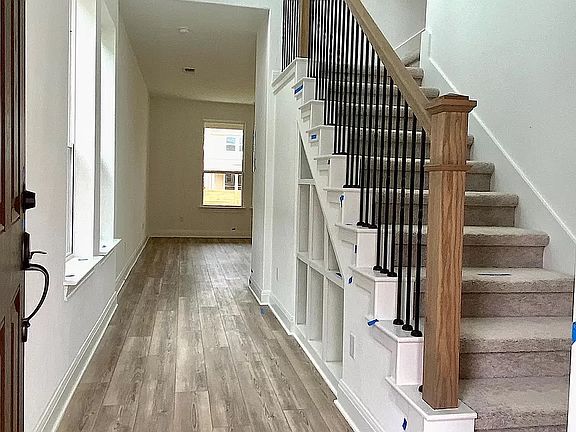 High vaulted entrance with stunning wooden staircase leading to second floor