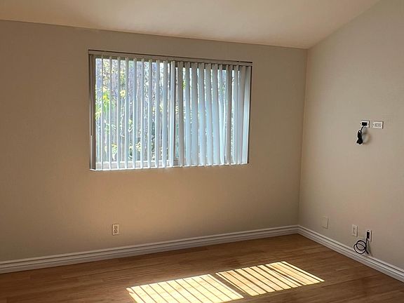 Bedroom with lots of natural light, view of greenbelt, bamboo flooring and fresh paint