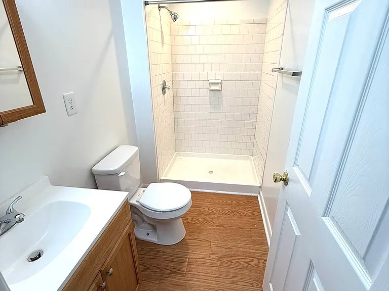Attached bathroom of primary bedroom, featuring an easy-access shower.