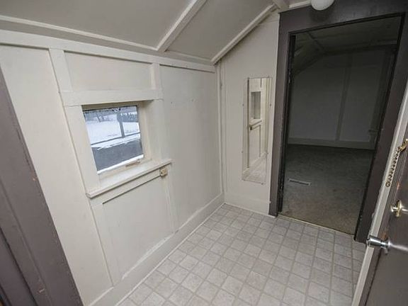 The following photos are of unit three which has been kept vacant in order to accommodate private showings of the property.  This picture shows the entryway and the doorway to the bedroom.