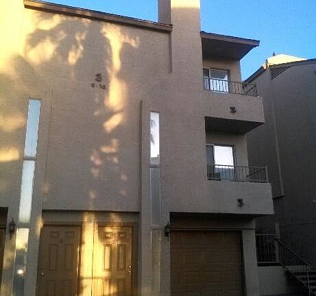 A view of the front door and attached garage