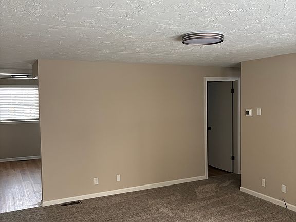 Living Room view into Kitchen and Bath