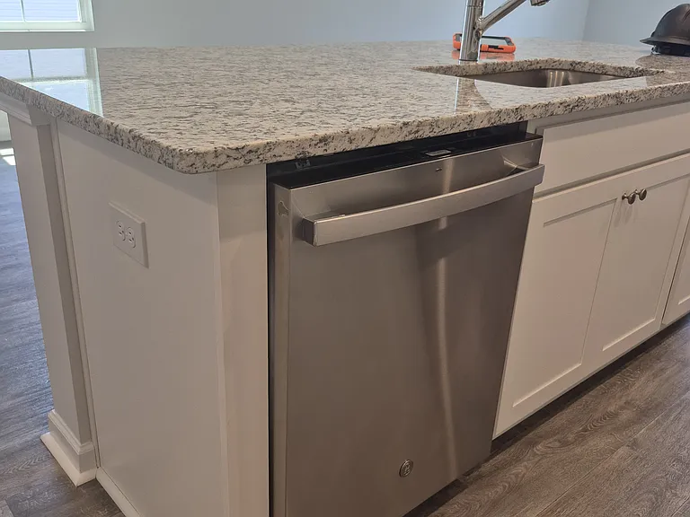 Kitchen island with sink, dishwasher and seating space