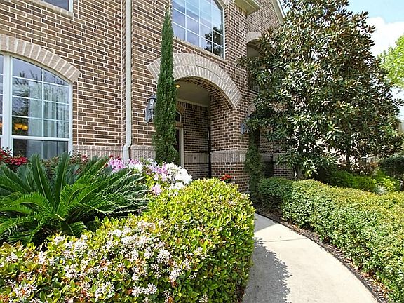 Beautiful brick home, inviting walkway for you and your guest with manicured landscape.