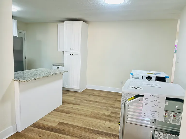 Dining area/kitchen. The washer/dryer in photo will be installed in garage.