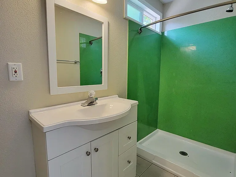 Full-size bathroom with full-size shower.
