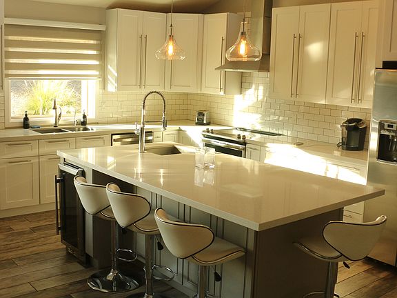 Spacious kitchen with new dishwasher and wine chiller; contemporary stainless stove/range and fridge; two sinks.