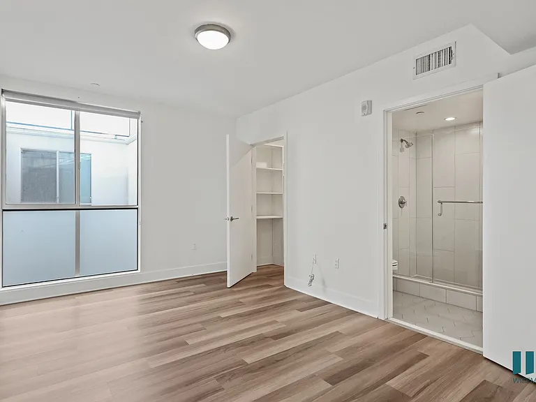 Bedroom with Bathroom, Walk-In Closet, Balcony, and Vinyl Flooring