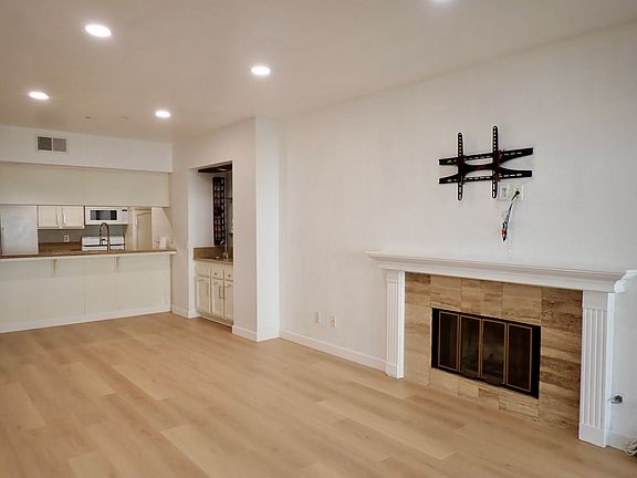 Living room with new floors. Recessed lighting throughout the property