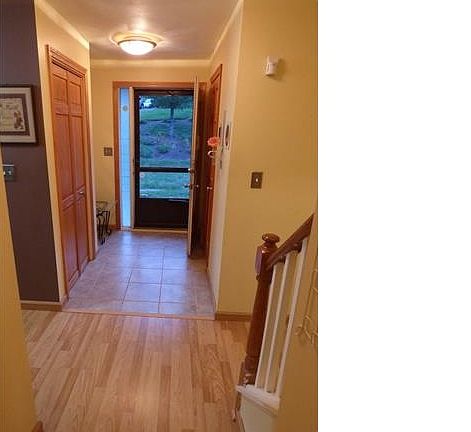 Entry with tile floor closet