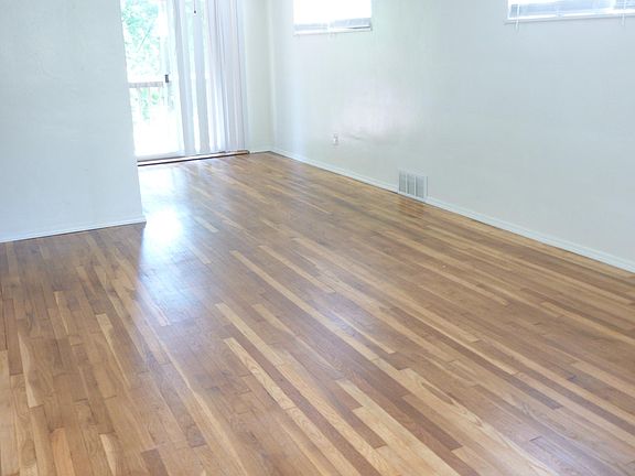 Newly refinished living room into dining room hardwood floor