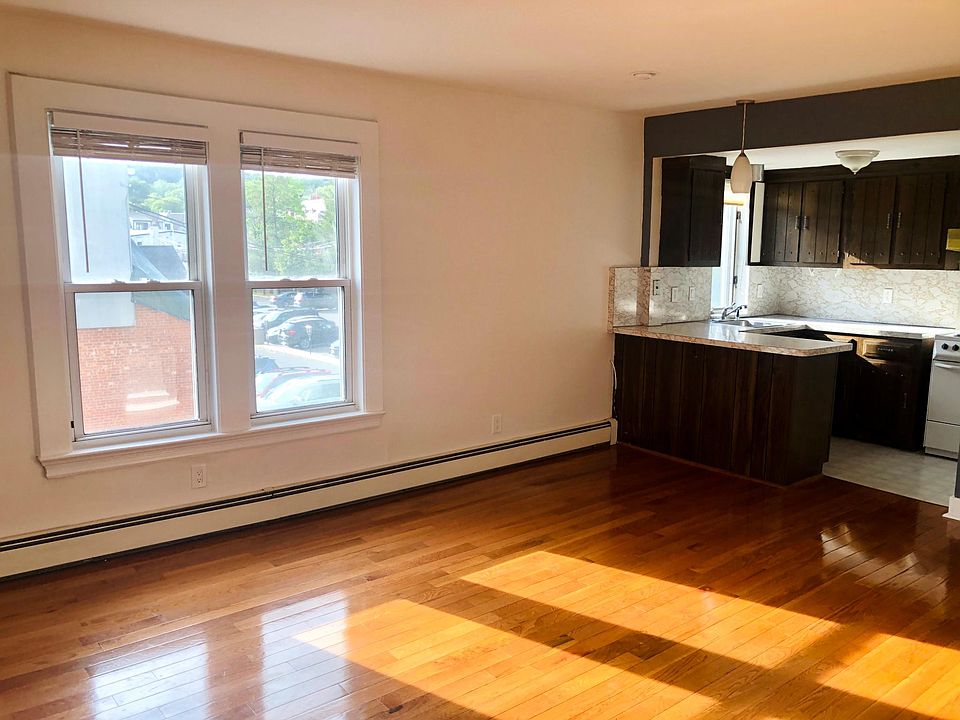 Living room with hardwood floors and kitchen