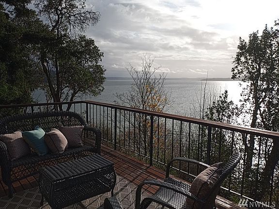 First time on the market for this custom built, high bank waterfront home in beautiful Normandy Park! The outbuilding was used as a playhouse!  Great for storing garden tools too.