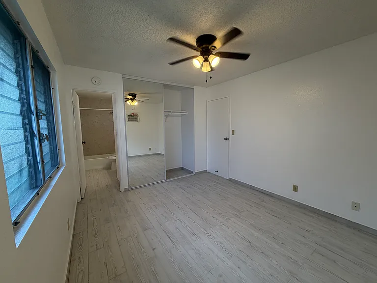 Primary bedroom with en suite bathroom, floor to ceiling closet doors