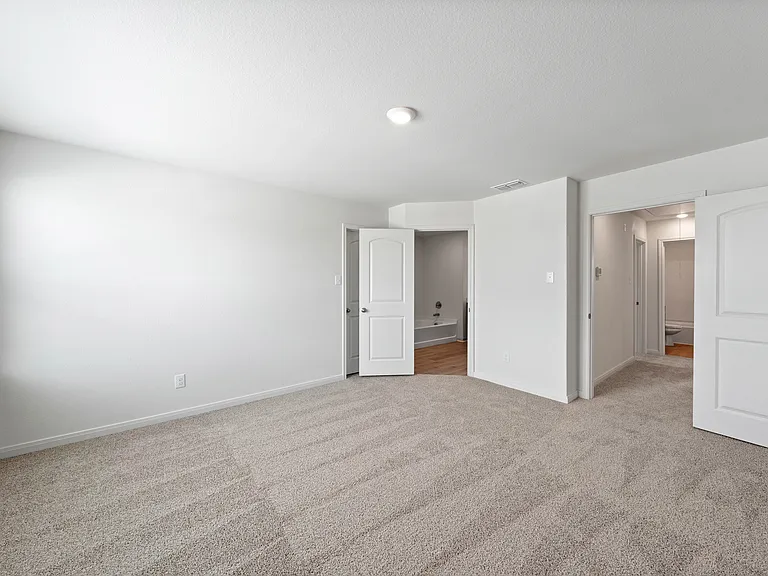 The master suite has a spacious bedroom, en-suite bathroom and walk-in closet.