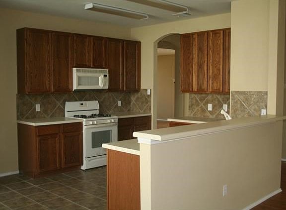 Kitchen, open to living and breakfast area, with hard tile, gas stove and new sink.