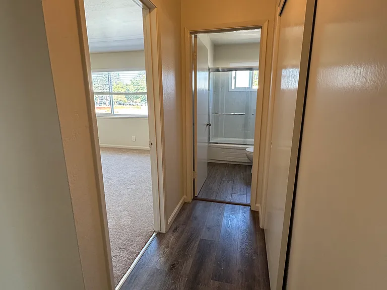 1BR hallway that leads to bedroom and bathroom
