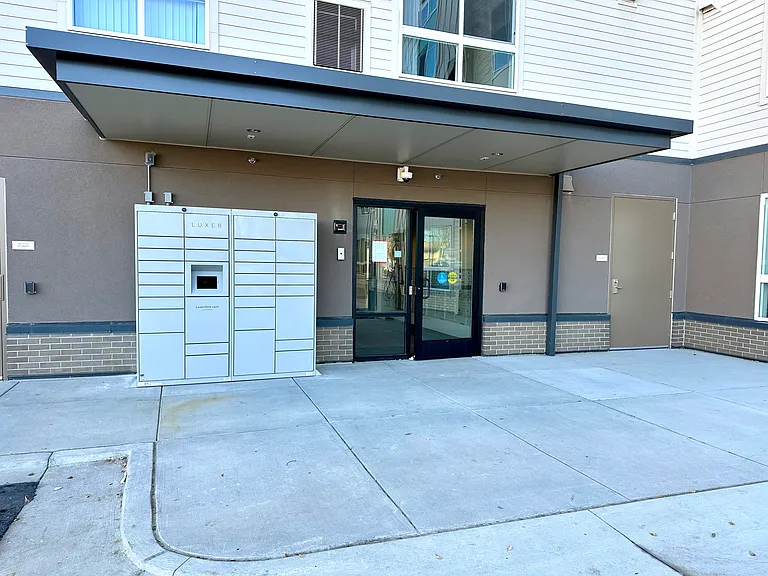 Main entrance off parking lot. Package lockers.