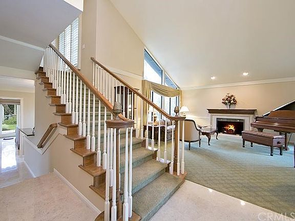 Grand 2-story foyer entrance with polished travertine flooring