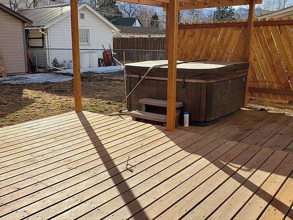 Fenced yard with hot tub and deck