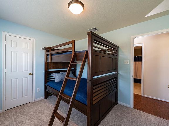 This secondary bedroom is spacious and peaceful.
