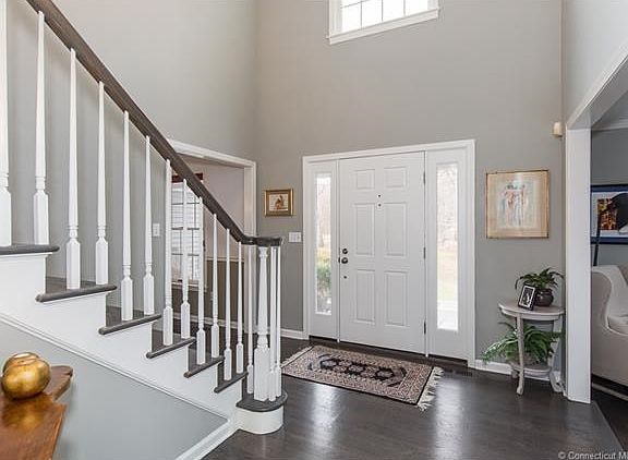 Foyer with high ceilings open to living room and dining room