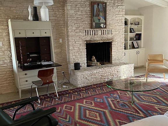 Family room. Tv can be mounted on stone wall. Has hardware prep_