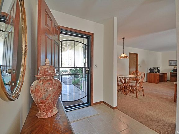 Entry features nice tiles and stained wood trim