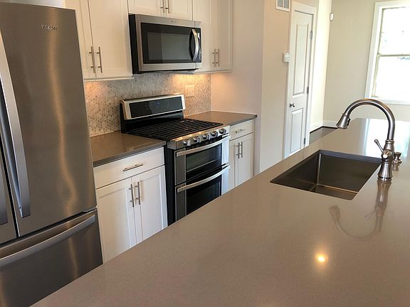 Central kitchen with large island and stainless steel applia